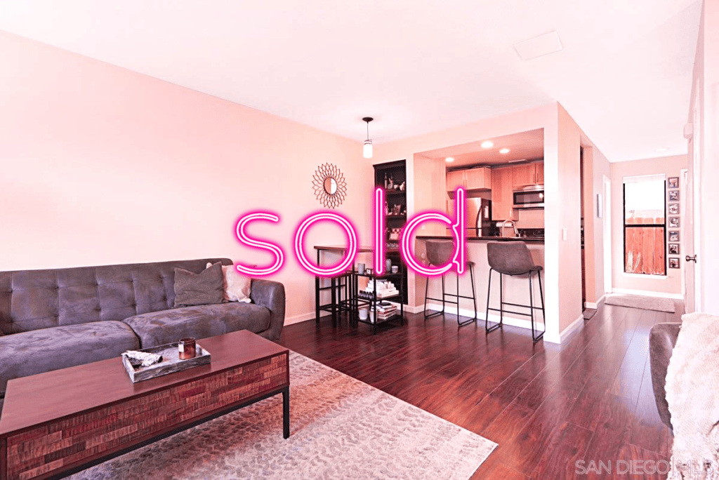 A sold home in san diego inside of the living room with the entry and seating area in the background